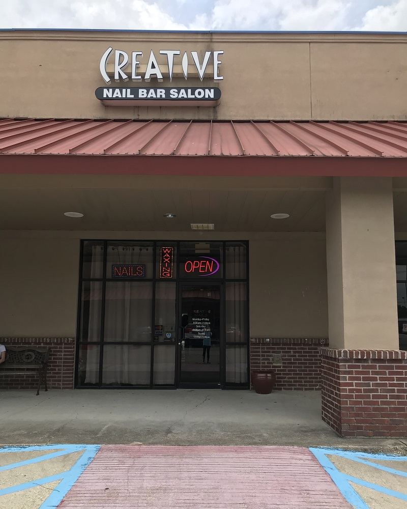 The storefront with the CREATIVE Nail Bar Salon sign